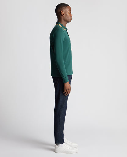 Man wearing a green Slim Fit Cotton-Stretch Pique Polo Shirt