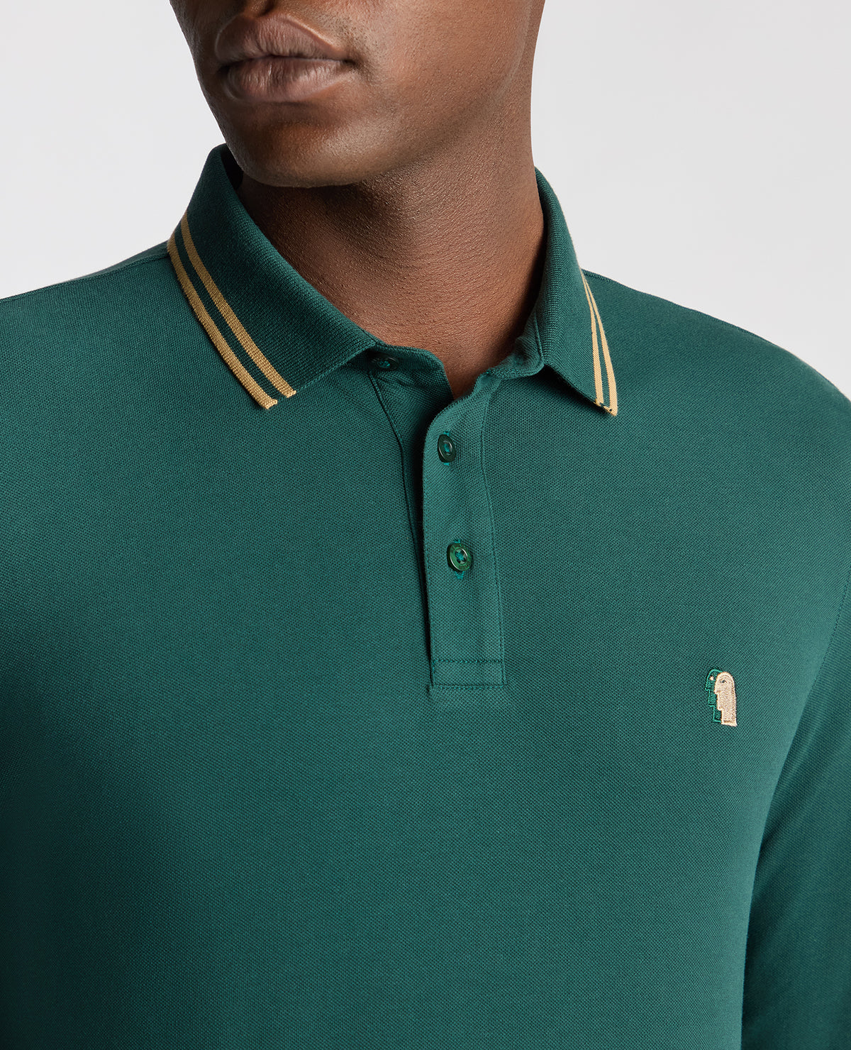 Man wearing a green Slim Fit Cotton-Stretch Pique Polo Shirt