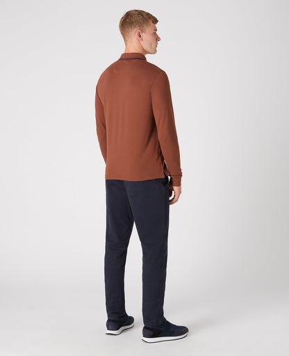 Man wearing a brown Slim Fit Cotton-Stretch Pique Polo Shirt