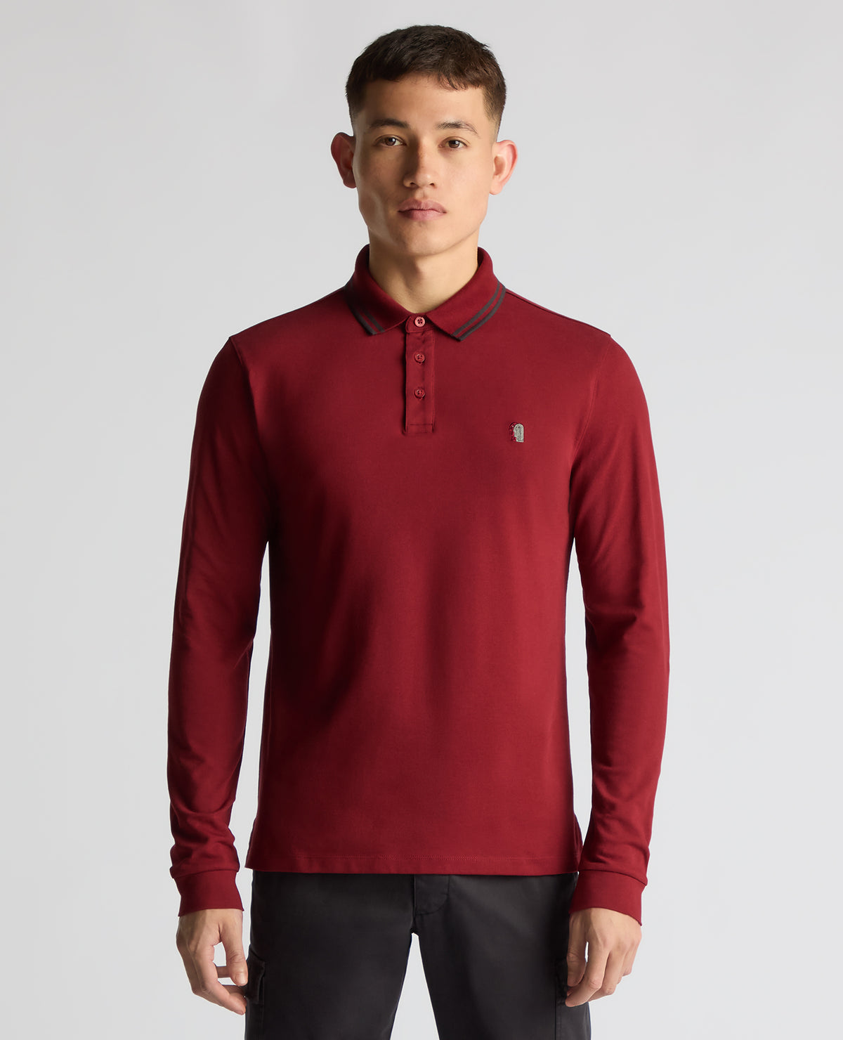 Man wearing a red Slim Fit Cotton-Stretch Pique Polo Shirt