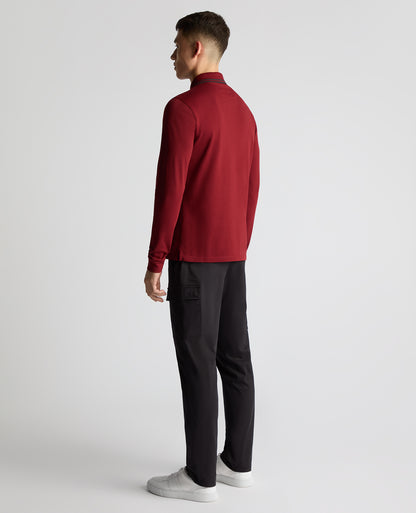 Man wearing a red Slim Fit Cotton-Stretch Pique Polo Shirt