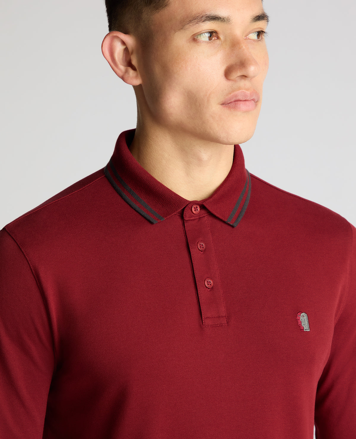 Man wearing a red Slim Fit Cotton-Stretch Pique Polo Shirt