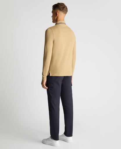 Man wearing a sand Slim Fit Cotton-Stretch Pique Polo Shirt