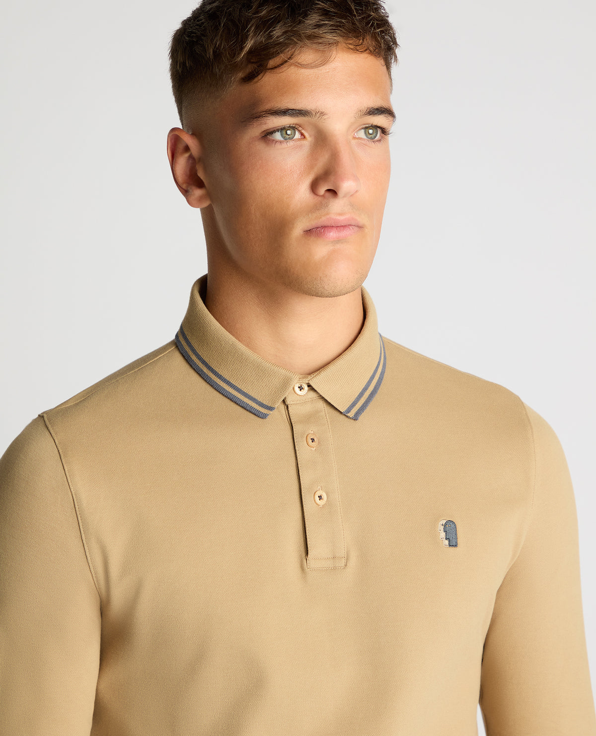 Man wearing a sand Slim Fit Cotton-Stretch Pique Polo Shirt