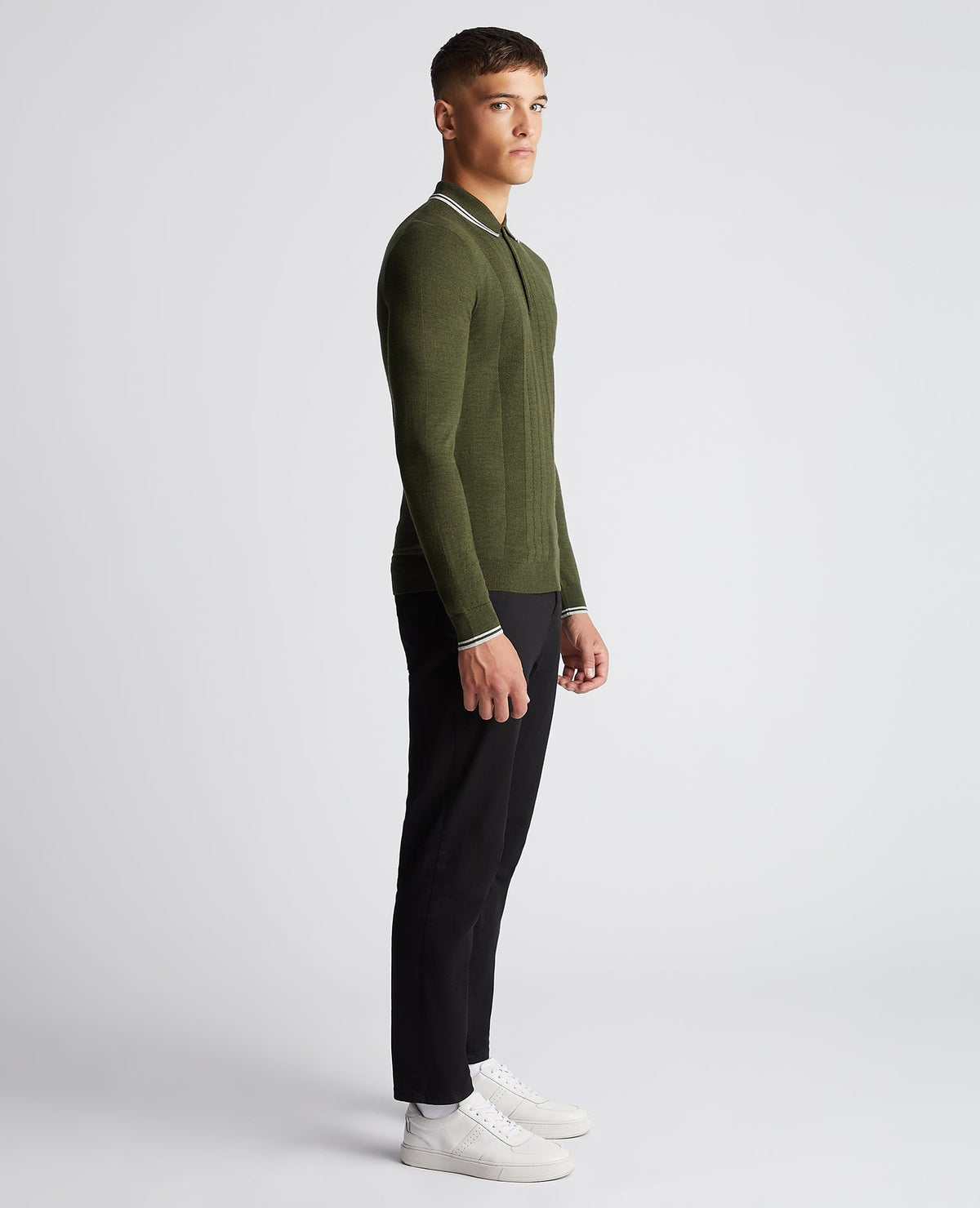 Man wearing a green Slim Fit Merino Wool-Blend Long Sleeve Knitted Polo