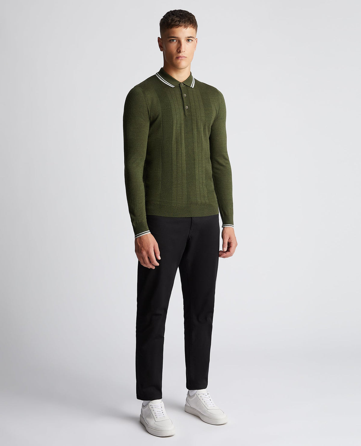 Man wearing a green Slim Fit Merino Wool-Blend Long Sleeve Knitted Polo