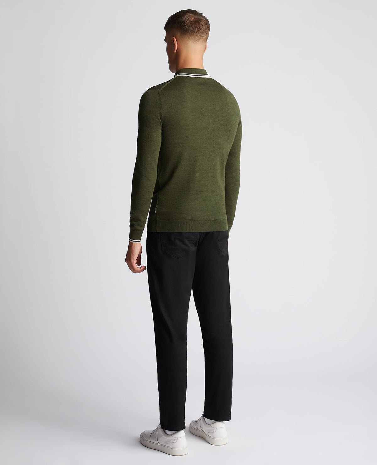 Man wearing a green Slim Fit Merino Wool-Blend Long Sleeve Knitted Polo