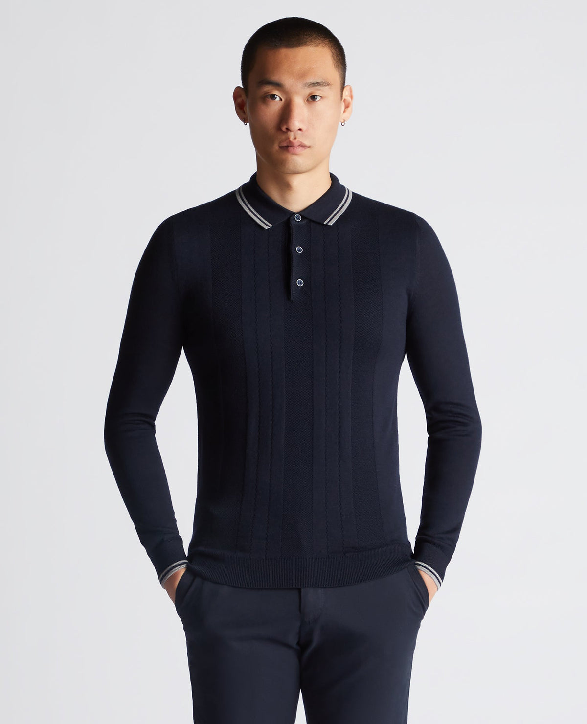 Man wearing a navy Slim Fit Merino Wool Knitted Polo