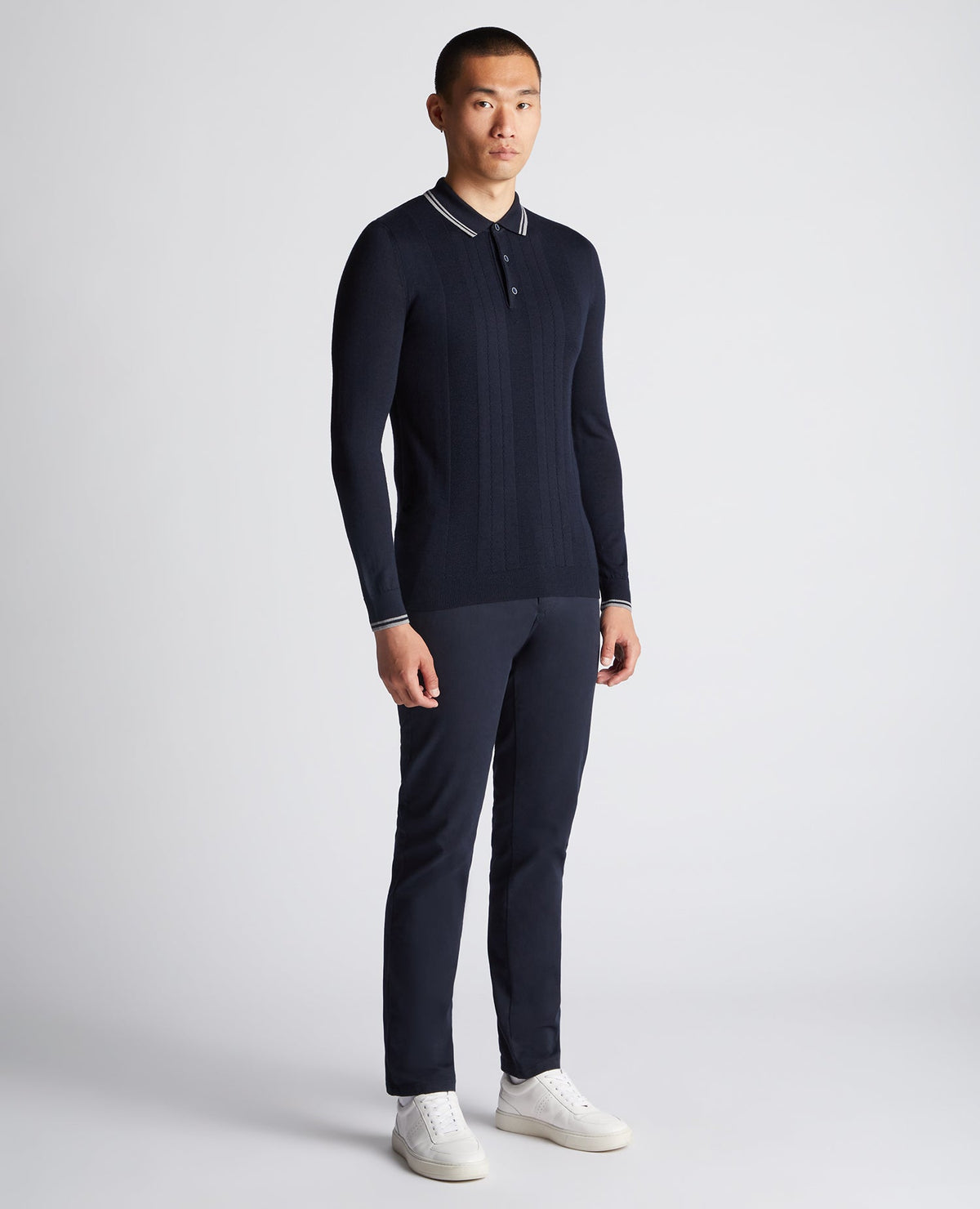 Man wearing a navy Slim Fit Merino Wool Knitted Polo