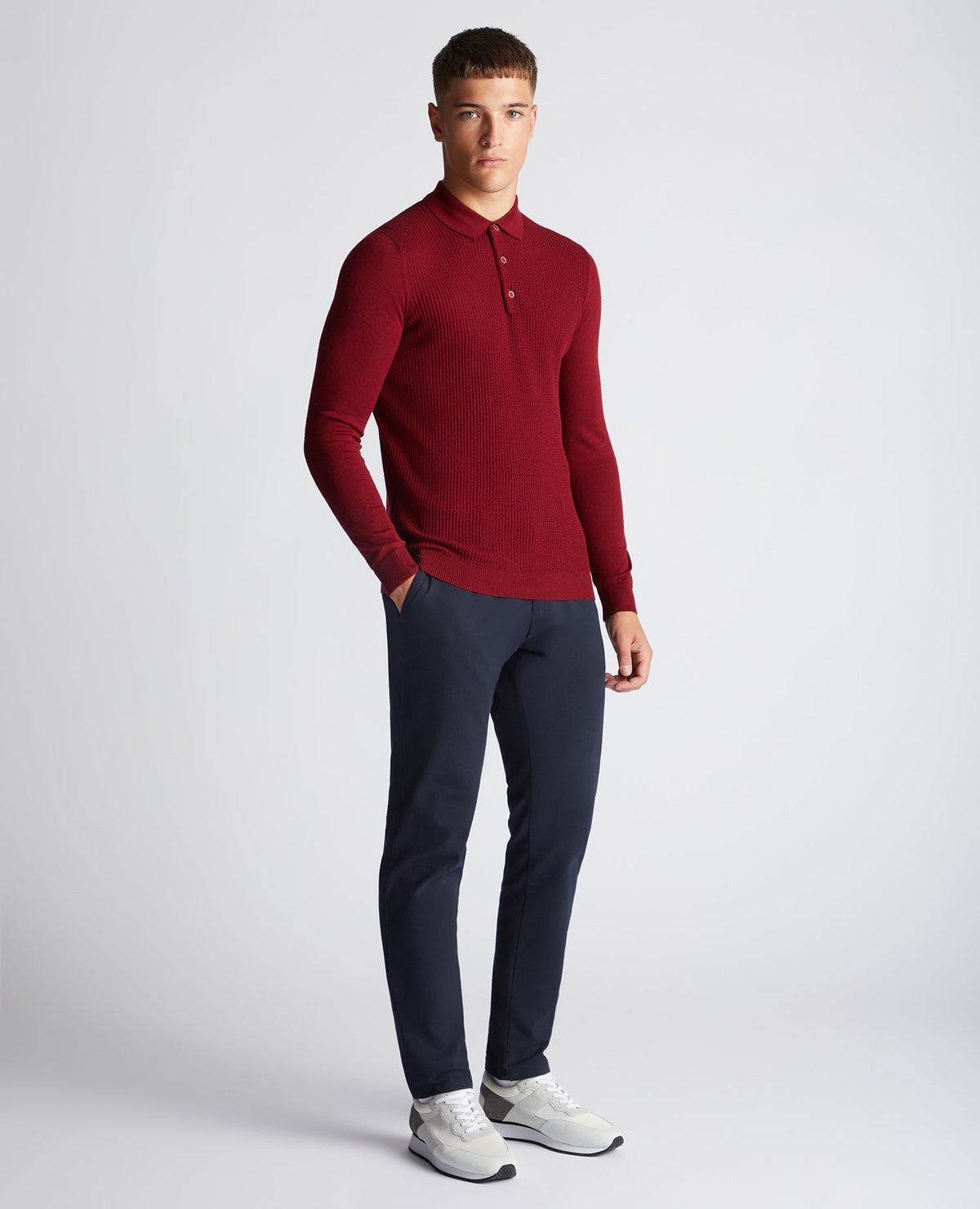 Man wearing a red Slim Fit Merino Wool-Blend Long Sleeve Knitted Polo