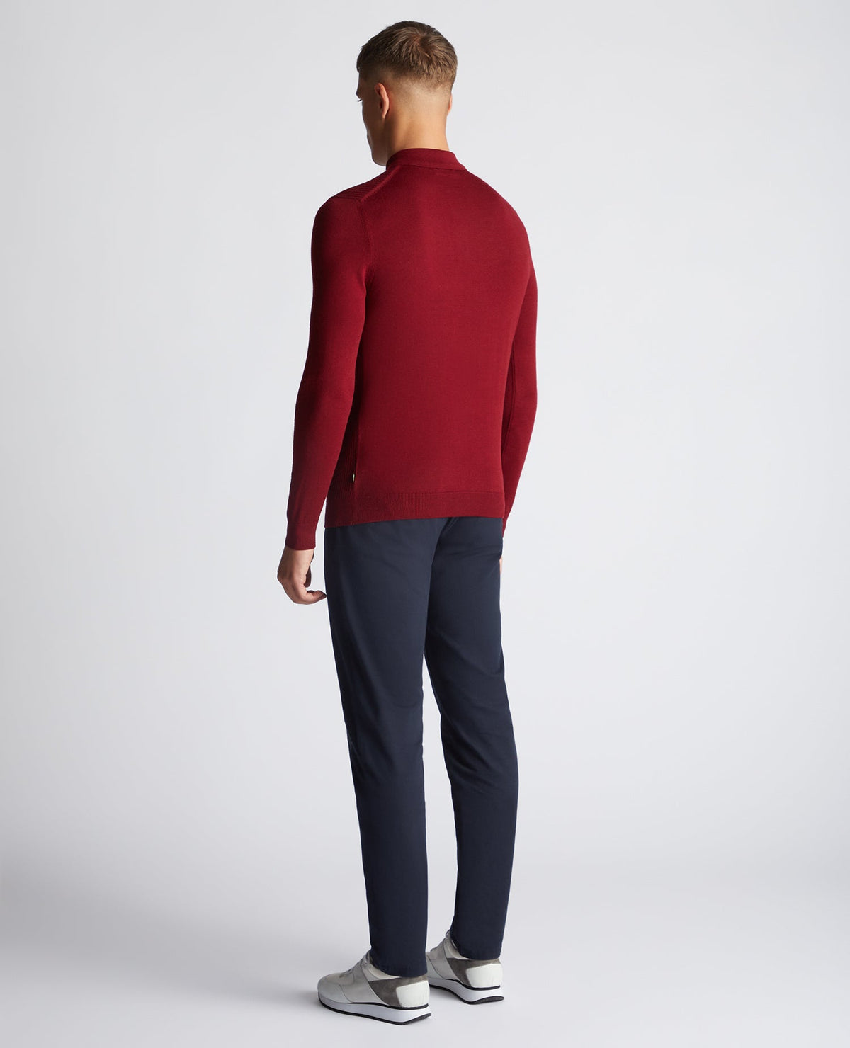 Man wearing a red Slim Fit Merino Wool-Blend Long Sleeve Knitted Polo