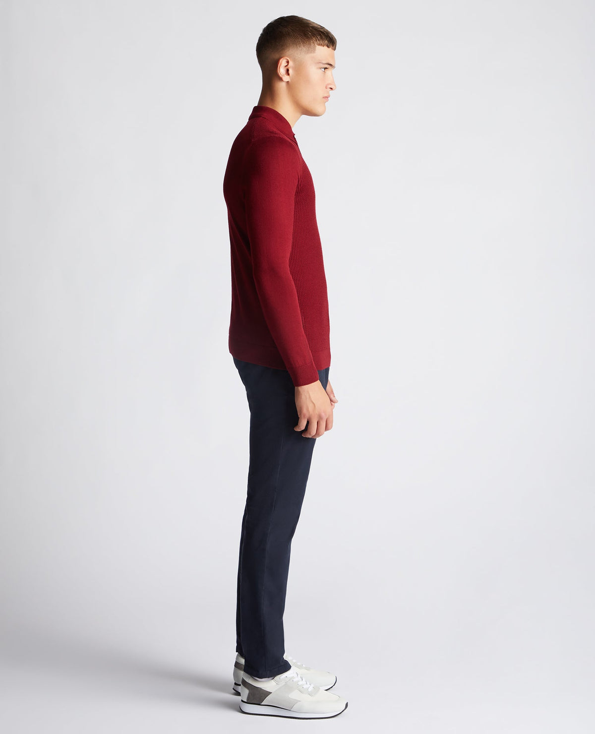 Man wearing a red Slim Fit Merino Wool-Blend Long Sleeve Knitted Polo