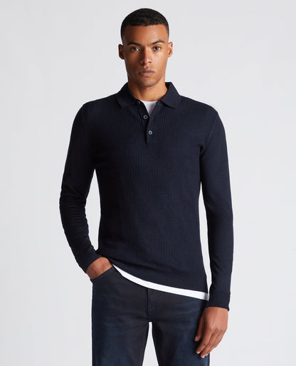 Man wearing a navy Slim Fit Merino Wool-Blend Long Sleeve Knitted Polo