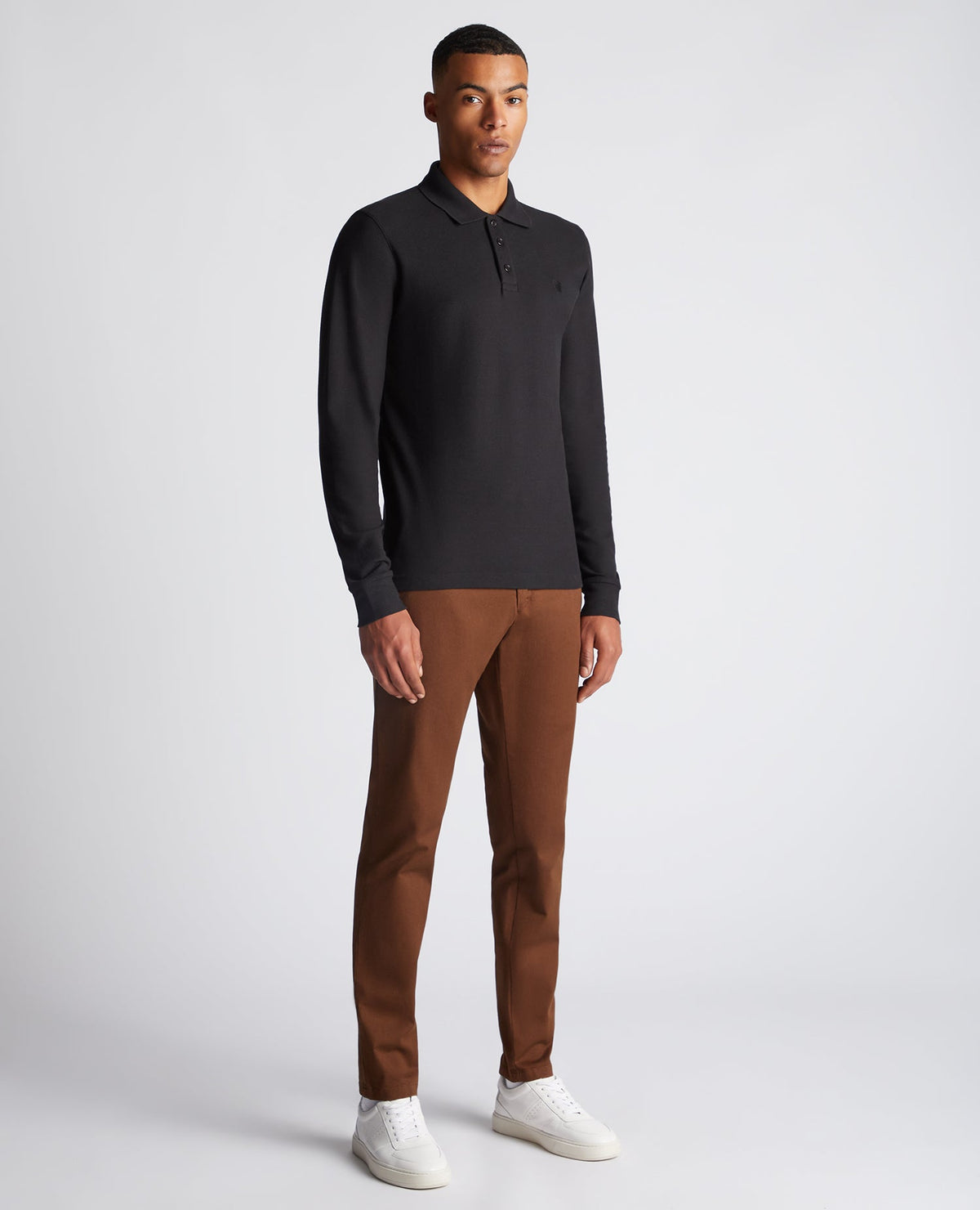 Man wearing a black Slim Fit Cotton-Stretch Pique Polo Shirt