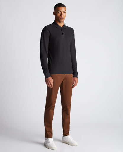Man wearing a black Slim Fit Cotton-Stretch Pique Polo Shirt