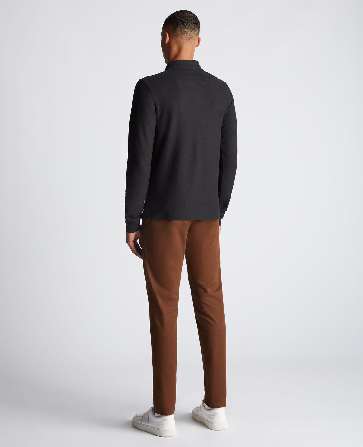 Man wearing a black Slim Fit Cotton-Stretch Pique Polo Shirt