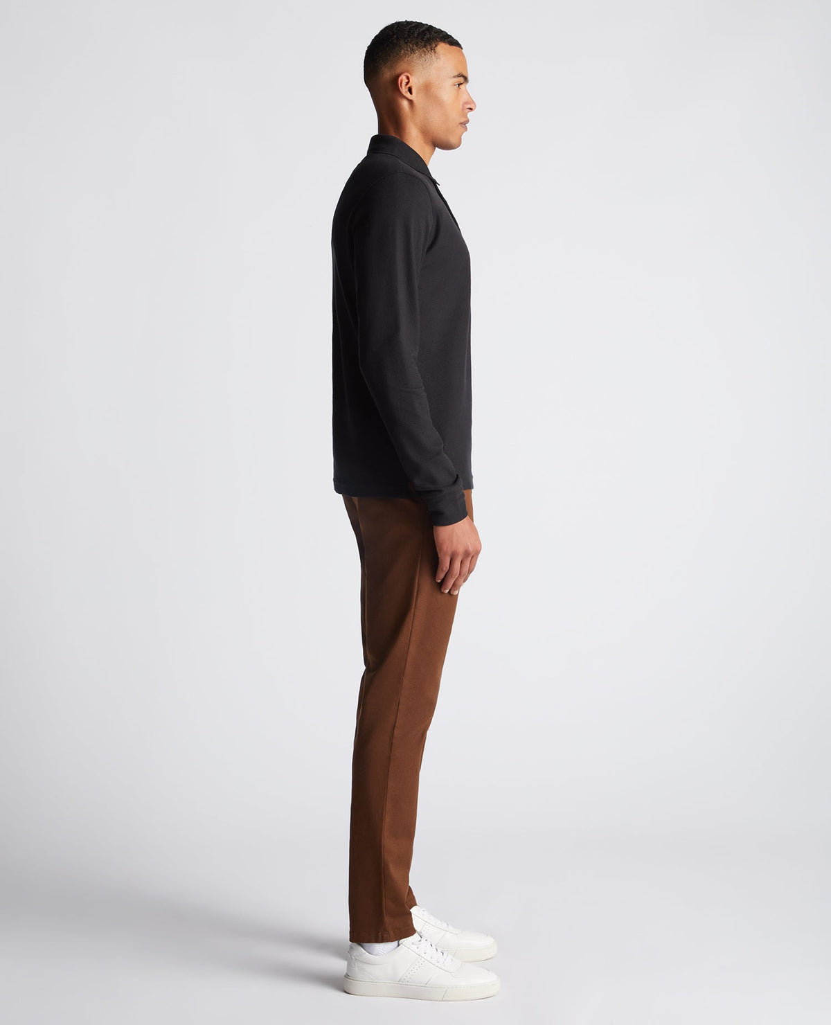 Man wearing a black Slim Fit Cotton-Stretch Pique Polo Shirt