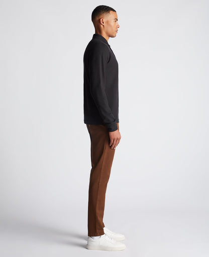 Man wearing a black Slim Fit Cotton-Stretch Pique Polo Shirt