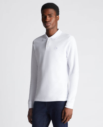 Man wearing a white Slim Fit Cotton-Stretch Pique Polo Shirt