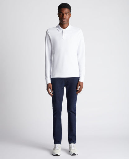 Man wearing a white Slim Fit Cotton-Stretch Pique Polo Shirt