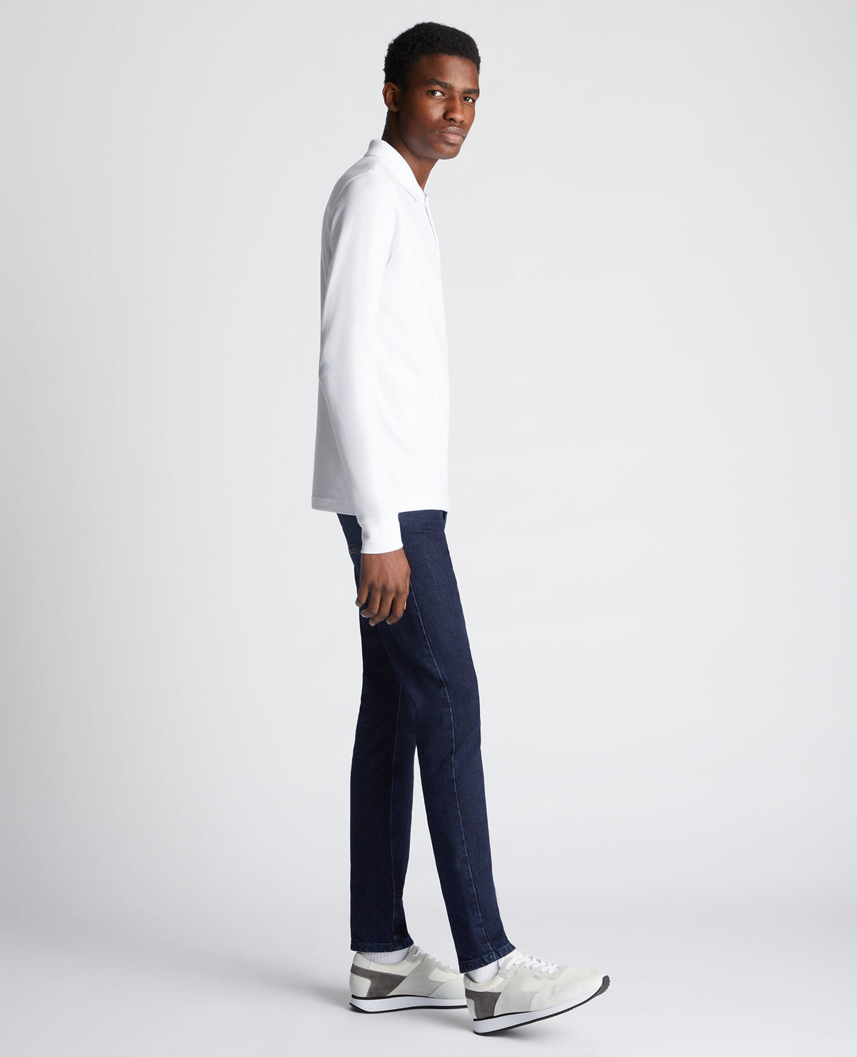 Man wearing a white Slim Fit Cotton-Stretch Pique Polo Shirt