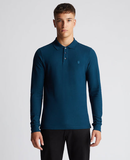 Man wearing a blue Slim Fit Cotton-Stretch Pique Polo Shirt