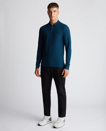Man wearing a blue Slim Fit Cotton-Stretch Pique Polo Shirt
