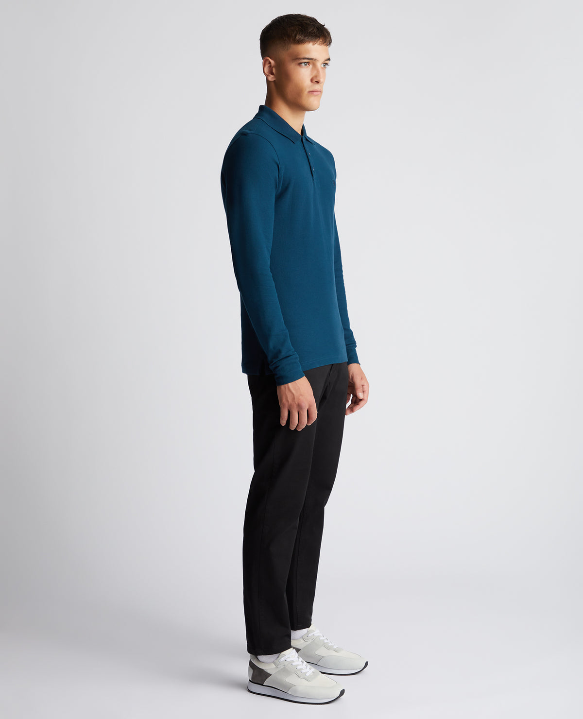 Man wearing a blue Slim Fit Cotton-Stretch Pique Polo Shirt