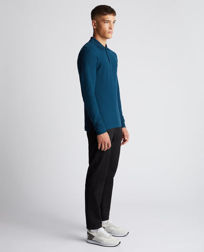Man wearing a blue Slim Fit Cotton-Stretch Pique Polo Shirt