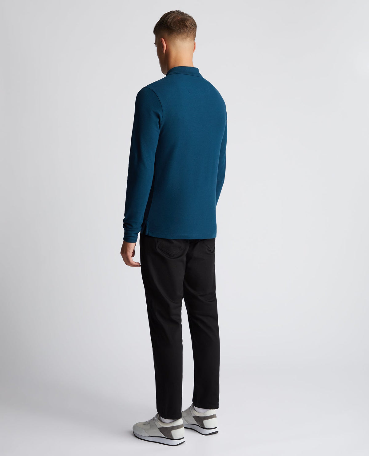 Man wearing a blue Slim Fit Cotton-Stretch Pique Polo Shirt