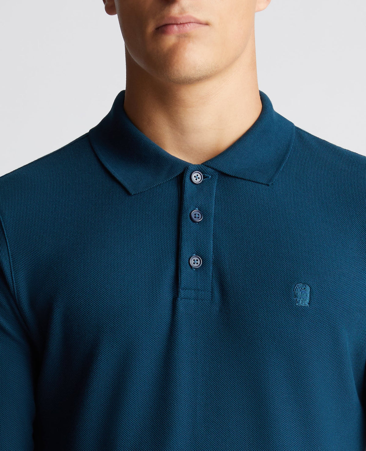 Man wearing a blue Slim Fit Cotton-Stretch Pique Polo Shirt