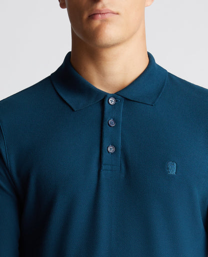 Man wearing a blue Slim Fit Cotton-Stretch Pique Polo Shirt