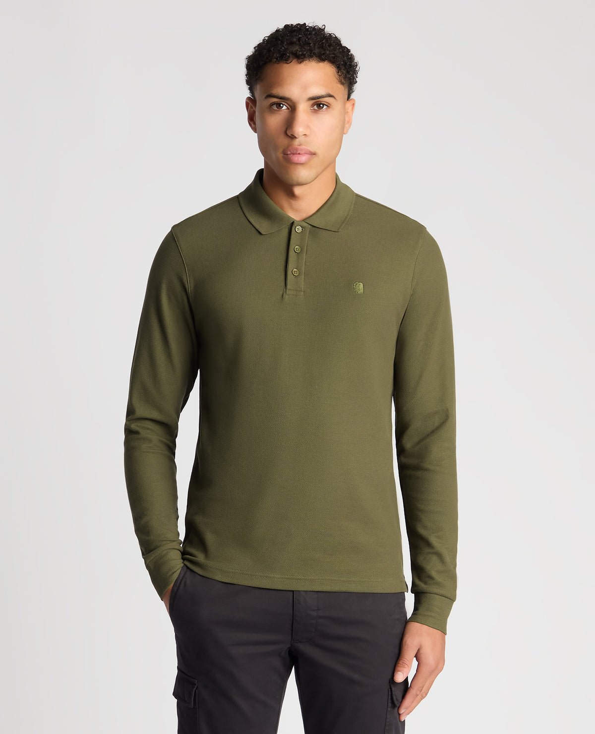 Man wearing a green Slim Fit Cotton-Stretch Pique Polo Shirt