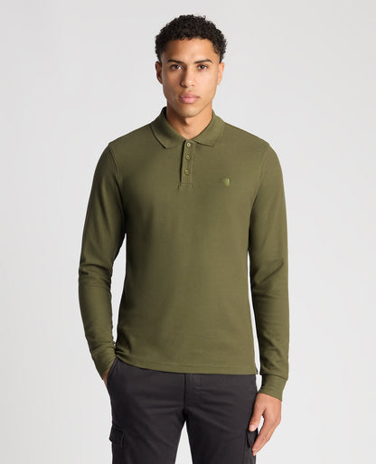 Man wearing a green Slim Fit Cotton-Stretch Pique Polo Shirt