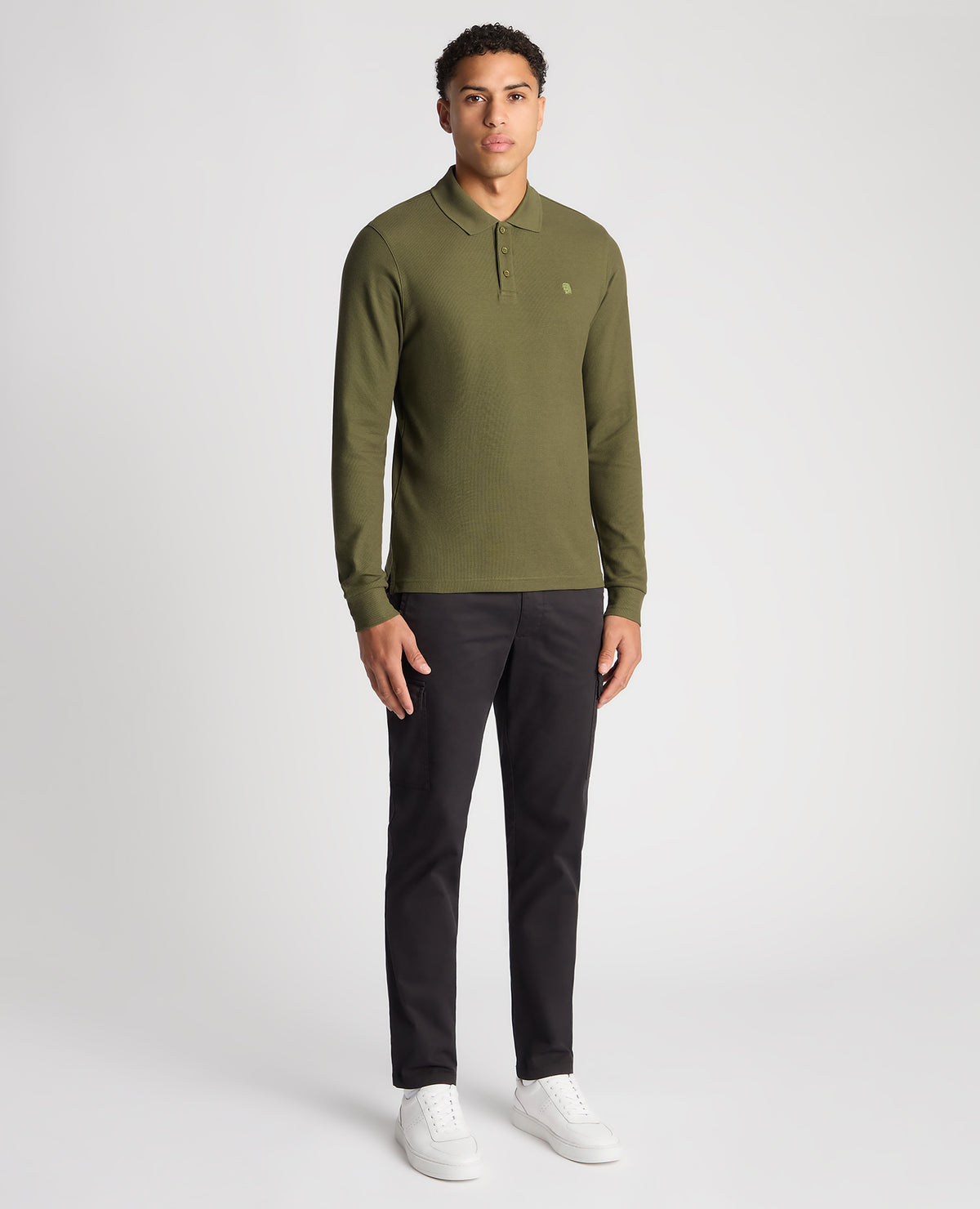 Man wearing a green Slim Fit Cotton-Stretch Pique Polo Shirt