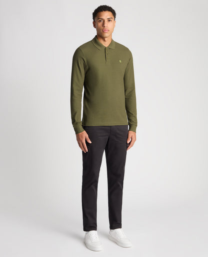 Man wearing a green Slim Fit Cotton-Stretch Pique Polo Shirt