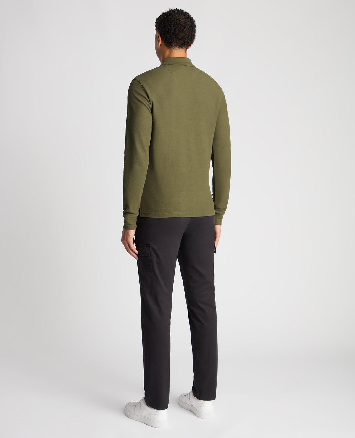 Man wearing a green Slim Fit Cotton-Stretch Pique Polo Shirt