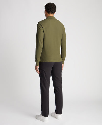 Man wearing a green Slim Fit Cotton-Stretch Pique Polo Shirt