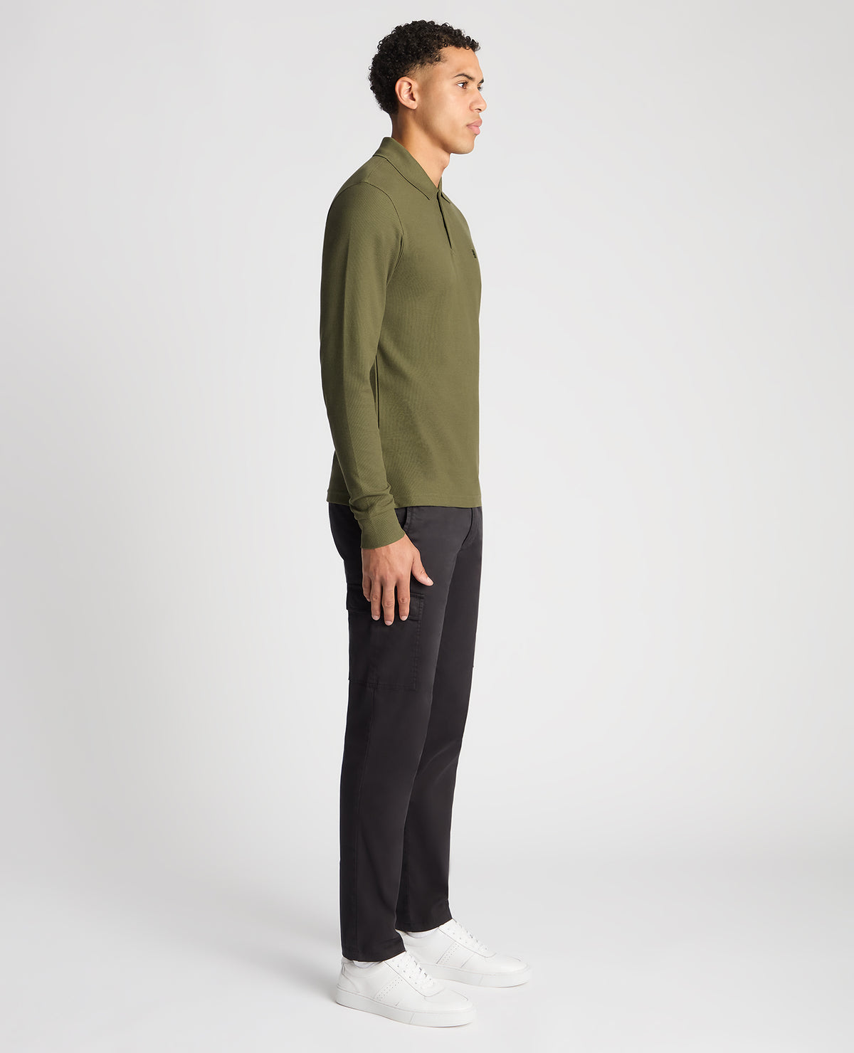 Man wearing a green Slim Fit Cotton-Stretch Pique Polo Shirt