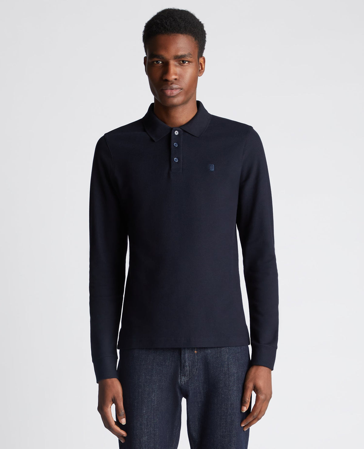 Man wearing a navy Slim Fit Cotton-Stretch Pique Polo Shirt