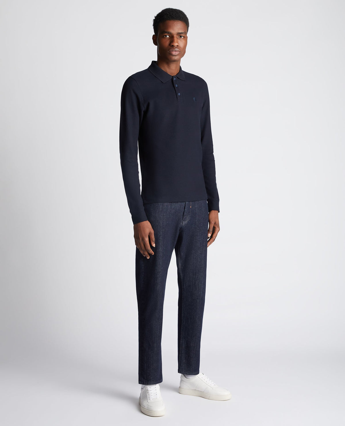 Man wearing a navy Slim Fit Cotton-Stretch Pique Polo Shirt