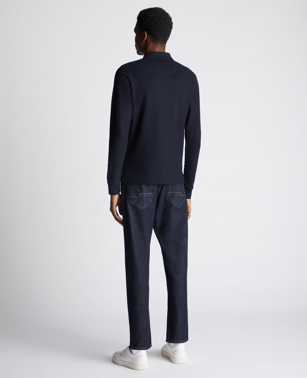 Man wearing a navy Slim Fit Cotton-Stretch Pique Polo Shirt