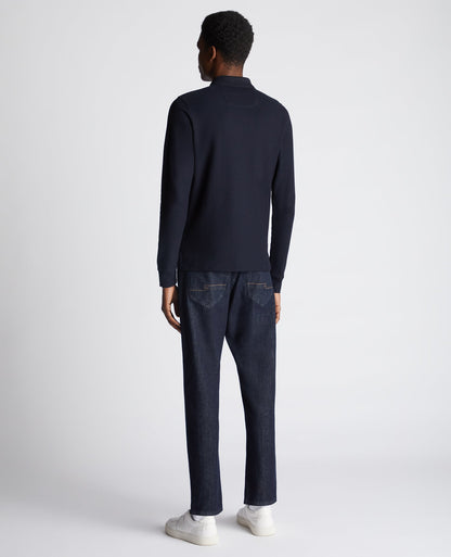 Man wearing a navy Slim Fit Cotton-Stretch Pique Polo Shirt