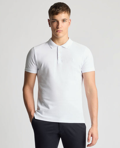 Man wearing a white Tapered Fit Cotton Pique Polo Shirt
