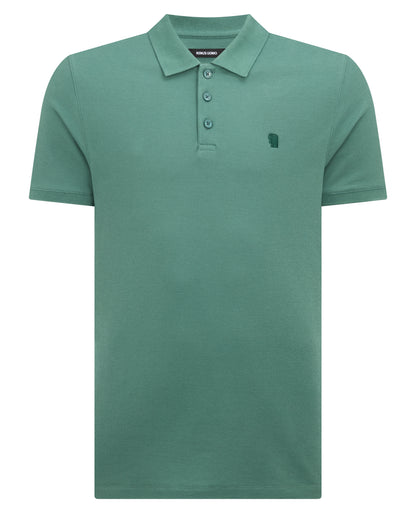 Man wearing a green Tapered Fit Cotton Pique Polo Shirt
