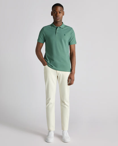 Man wearing a green Tapered Fit Cotton Pique Polo Shirt