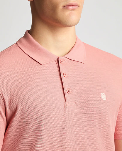 Man wearing a red Tapered Fit Cotton Pique Polo Shirt