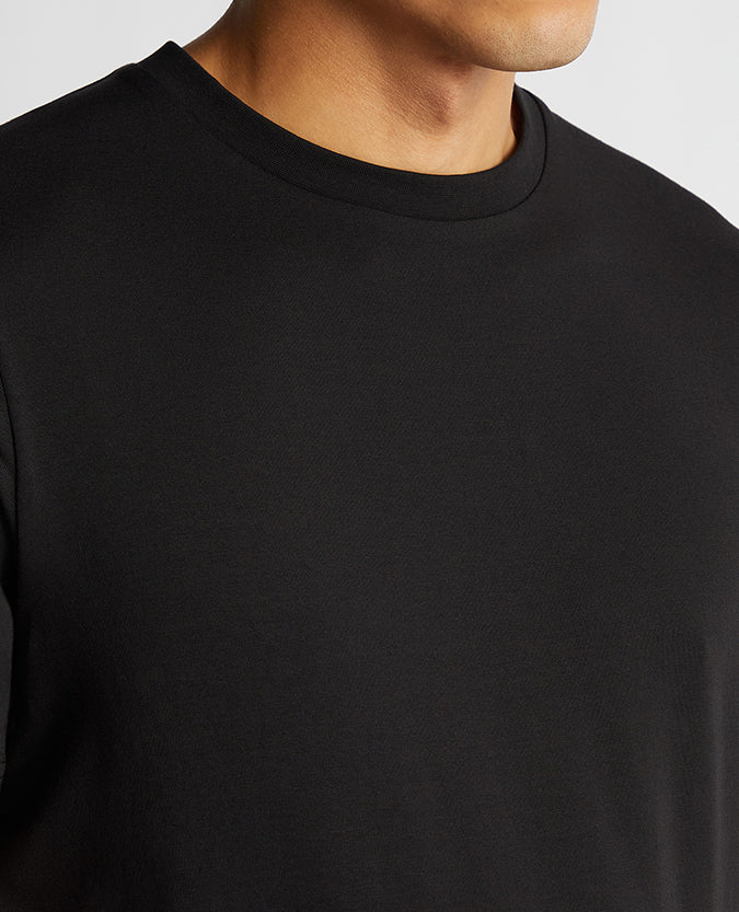 Man wearing a black Relaxed Fit Crew Neck Tencel T-Shirt