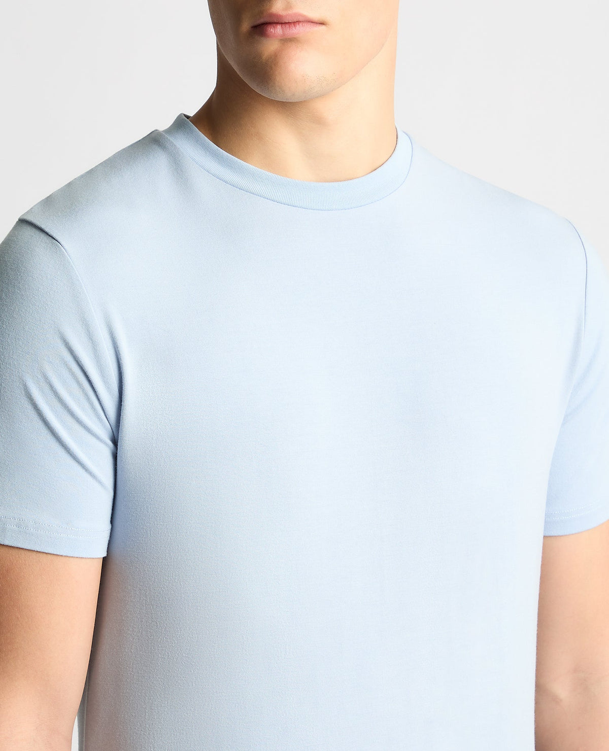Man wearing a blue Relaxed Fit Crew Neck Tencel T-Shirt