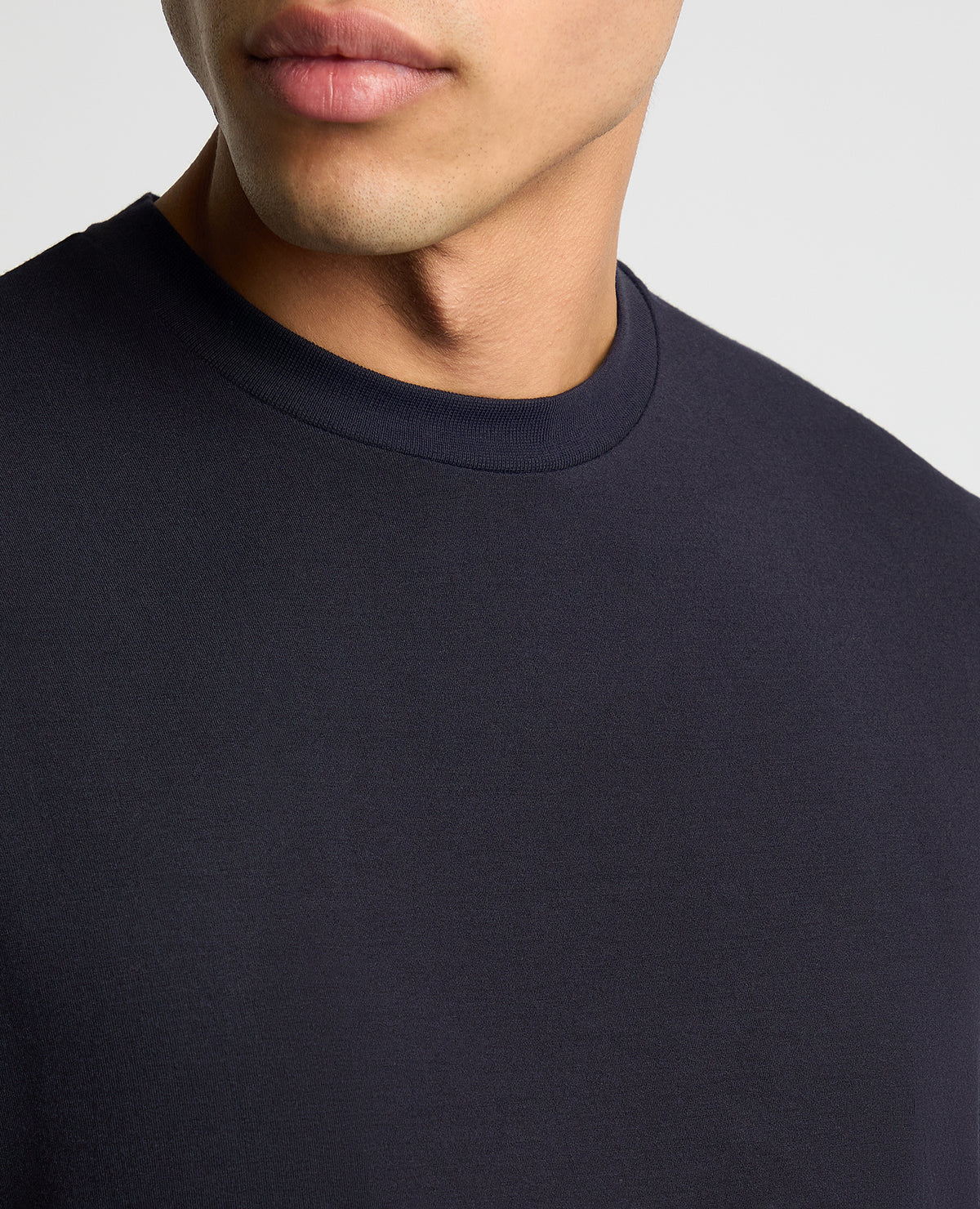 Man wearing a navy Relaxed Fit Crew Neck Tencel T-Shirt